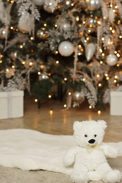 Urso Pelúcia Senta Perto Uma Árvore Natal Brilhante Decorada — Fotografia de Stock