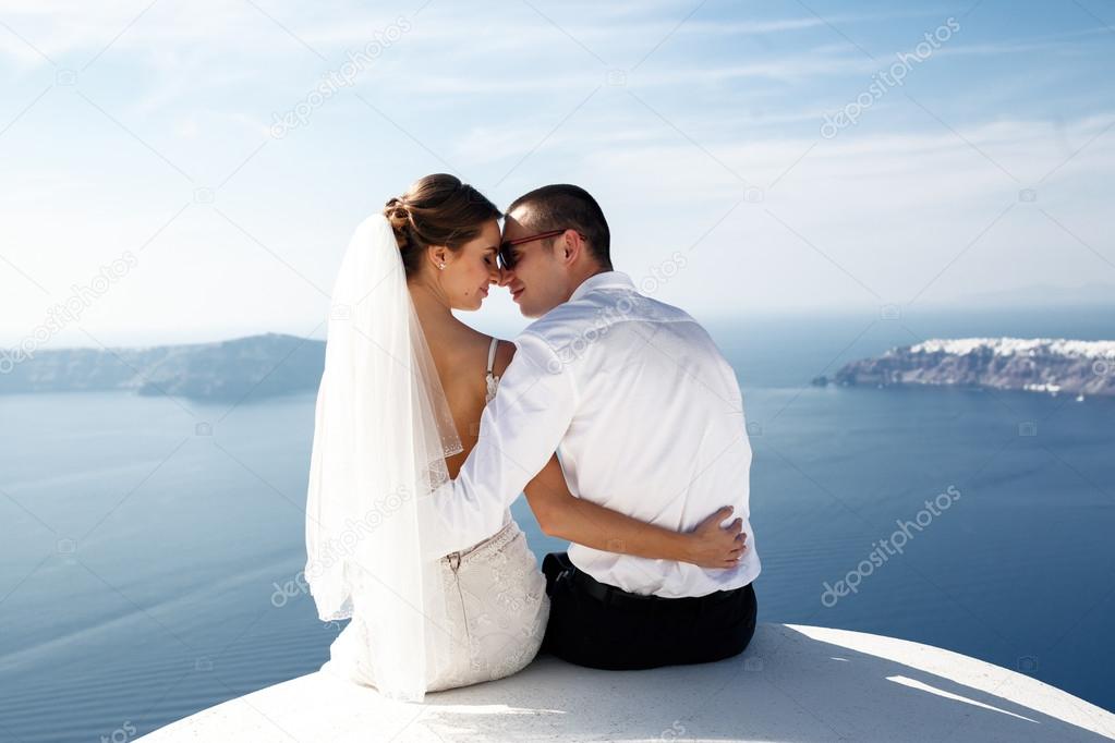 Happy married couple kissing on terrace