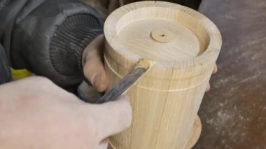carpenter is putting putty on the butt of wooden blank
