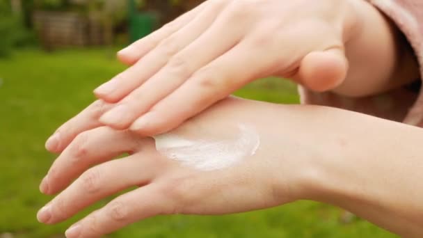 Hermosas manos de mujeres que aplican crema en — Vídeo de stock