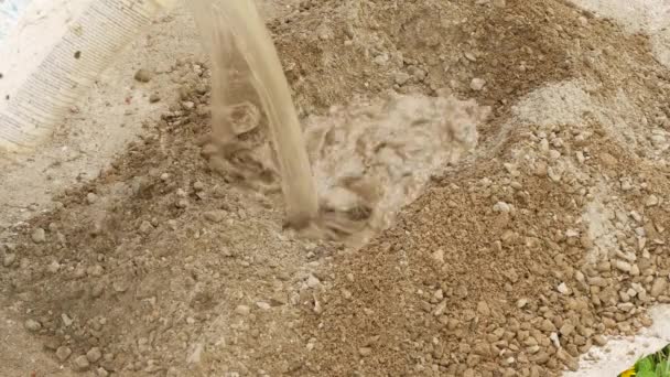 Bouwplaats: Water toevoegen aan cement in close-up — Stockvideo