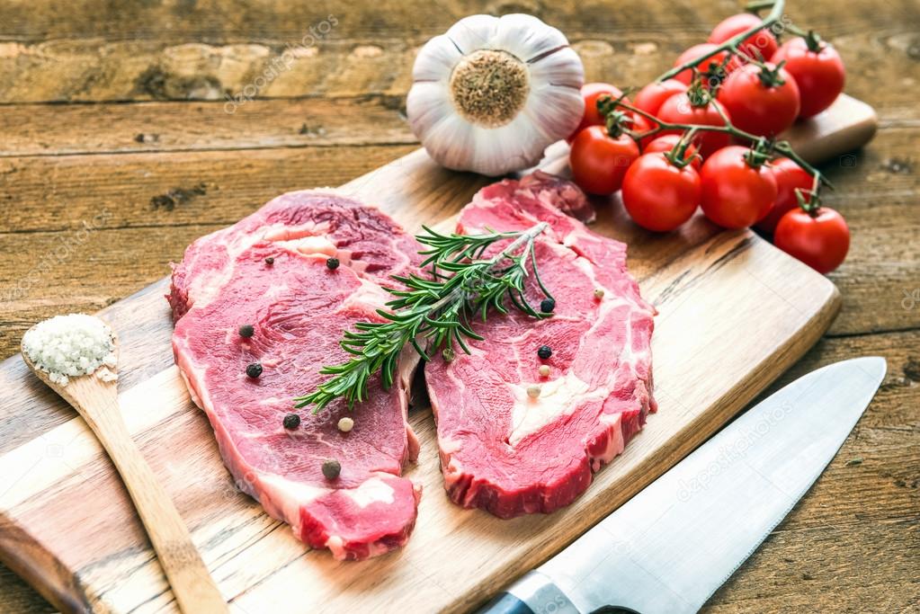 Raw fresh meat Ribeye steak entrecote on wooden background