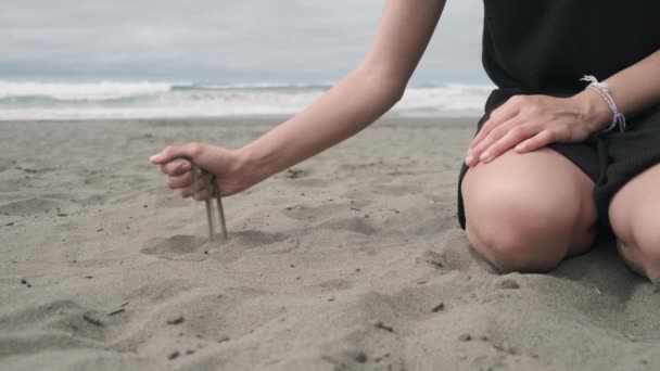 Woman Beach Dropping Black Sand Her Hand — Stock Video