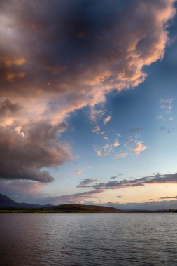 Gölde. yağmurdan sonra muhteşem gün batımı. Düşük anahtar, koyu arka plan, spot aydınlatma ve zengin eski ustalar