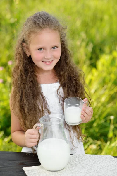Adorable chica sonriente desayunando bebiendo leche al aire libre verano — Foto de Stock