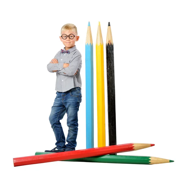 Happy boy in glasses and bowtie posing full length with a huge pencil. Educational concept. Isolated over white. — Stock Photo, Image