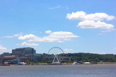 National Harbor waterfront with Ferris wheel under a blue cloudy sky in Maryland, USA clipart