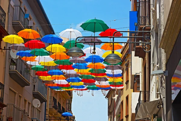 Street installation of colorful umbrellas.