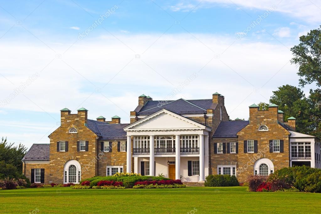 Glenview historic mansion with formal gardens at sunset.