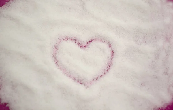 Forma do coração desenhada sobre fundo de açúcar granulado branco. Coração de açúcar doce com foco seletivo. Flat lay, vista superior — Fotografia de Stock