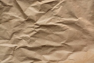 Kahverengi buruşuk ya da eski parşömen kağıdı, kırışık yüzey, metin için arkaplan, kağıt dokusu