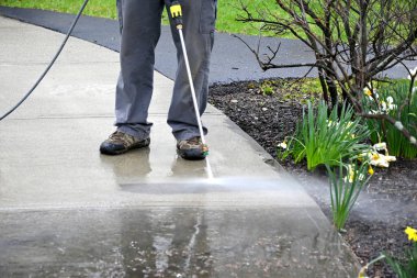 man cleans path. Pearson uses power washer, spring cleaning.  clipart
