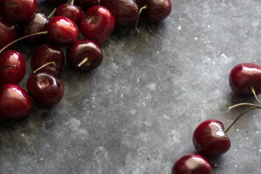 Ripe and juicy cherry on a dark background, space for text