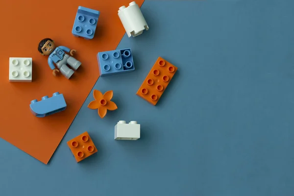 stock image constructor lies on an orange-blue background, top view, photo with empty space