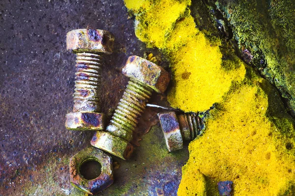 Rusty old bolts and an old polyurethane foam — Stock Photo, Image