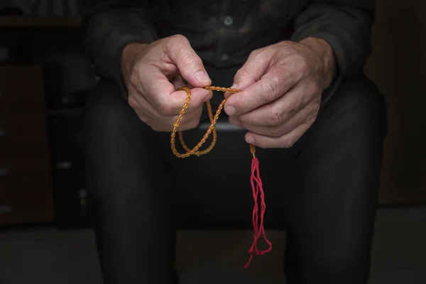 Close view of men's hands with rosary — Stock Photo, Image