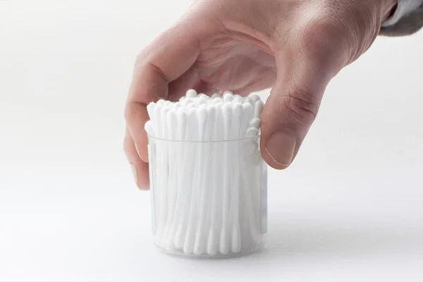 Male's hand taking a permanent box with many white cotton buds — Stock Photo, Image