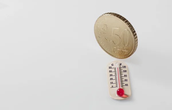 Fifty euro cent and thermometer — Stock Photo, Image