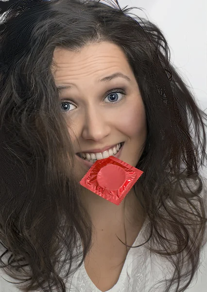 Girl with  with red condom pack — Stock Photo, Image
