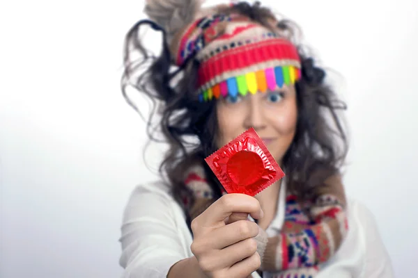 Chica con un paquete de condón rojo en la mano —  Fotos de Stock