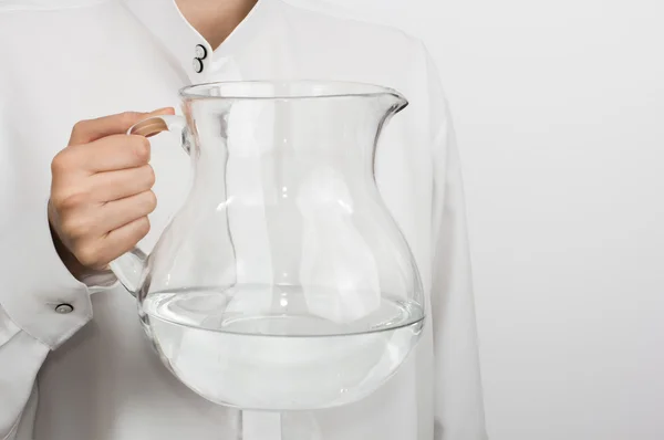 Girl's hand with a glass pitcher — Stock Photo, Image