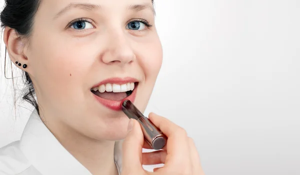 Mädchen färbt Lippen mit Lippenstift — Stockfoto