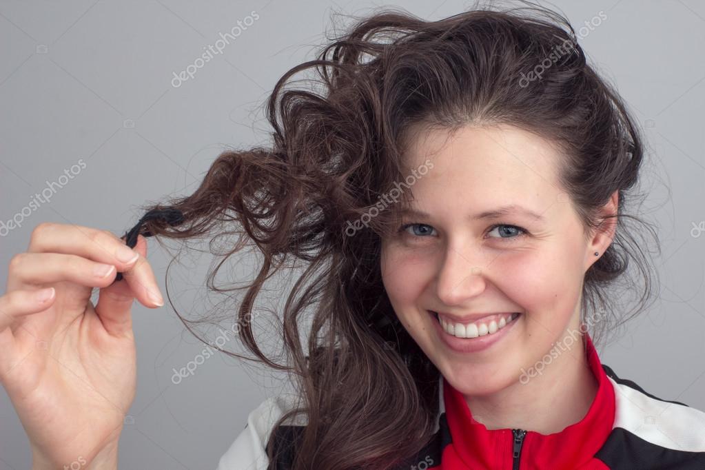 Smiling Girl S Face And Hand Tousling Hair Stock Photo