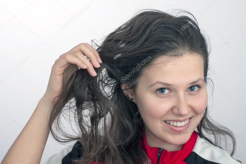 Smiling Girl S Face And Hand Tousling Hair Stock Photo