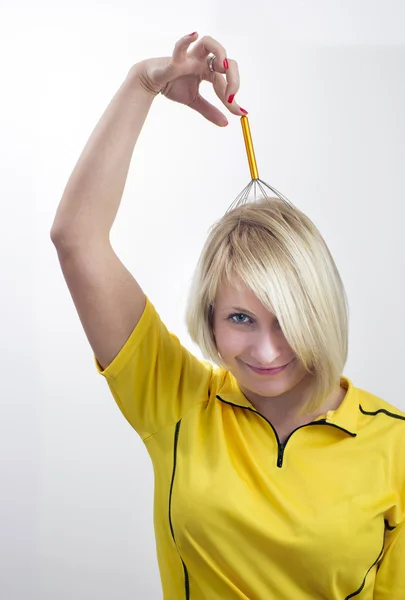 Smiling woman with a head massage tool — Stock Photo, Image