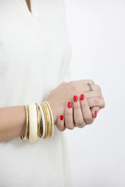 Woman's hands with yellow bracelets — Stock Photo, Image