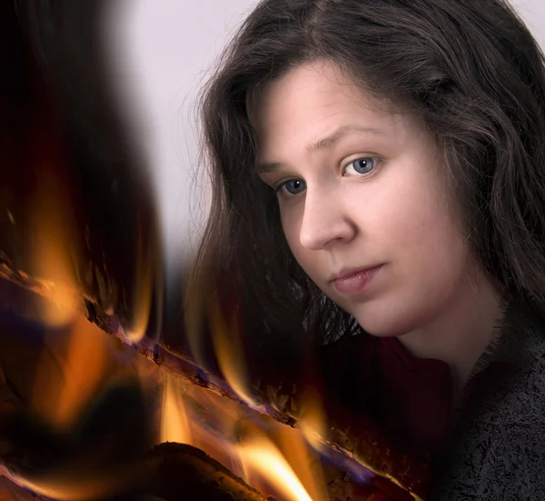 Girl's face and a flame — Stock Photo, Image