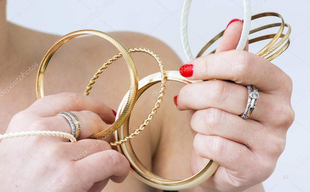 Woman's hands with gold bracelets