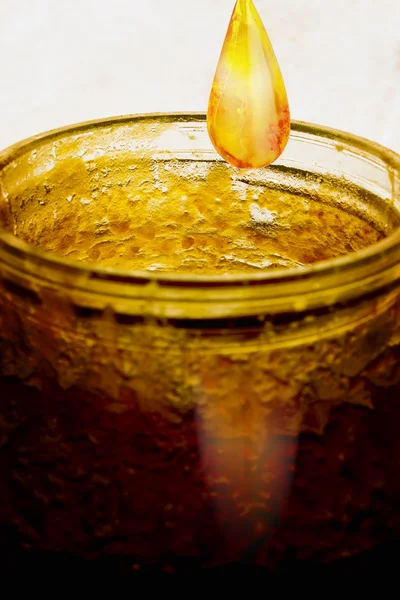 Rim of the jar with crystallized honey and honey drop — Stock Photo, Image