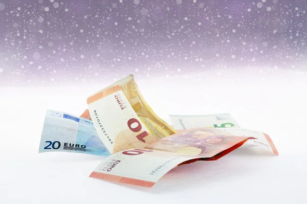 Falling snow and  euro banknotes — Stock Photo, Image
