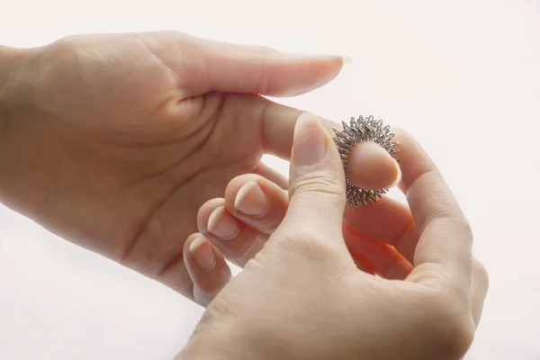 Manos de mujer con anillo de masaje en un dedo — Foto de Stock