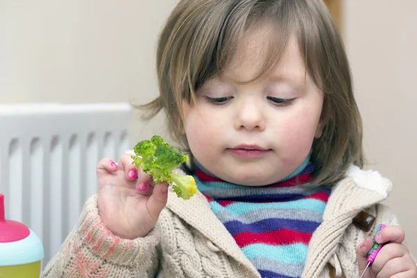 Liten flicka vars ansikte och tröja är suddig med färg — Stockfoto