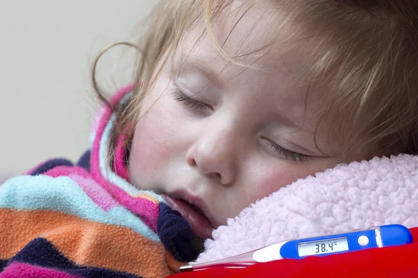 Electronic thermometer and a little sick girl Stock Photo