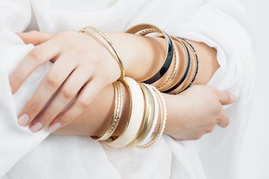 Girl hands with golden bracelets