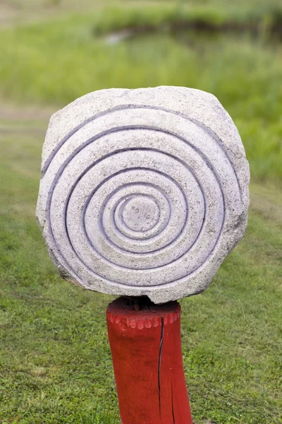 Sculpture made of stone with  a spiral symbol — Zdjęcie stockowe