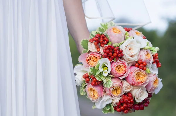 Beautiful colorful wedding bouquet in a hand of a bride — Stock Photo, Image