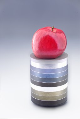 Bir metalik Yüzükler kaide üzerinde kırmızı elma