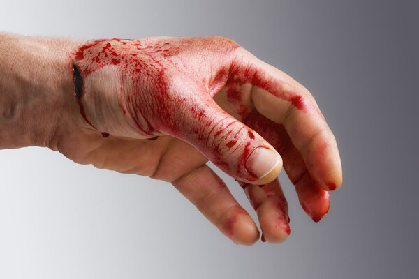 Bloody man's hand with a wound