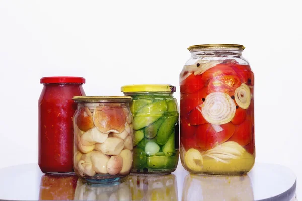 Mushrooms and vegetables in glass jars — Stock Photo, Image