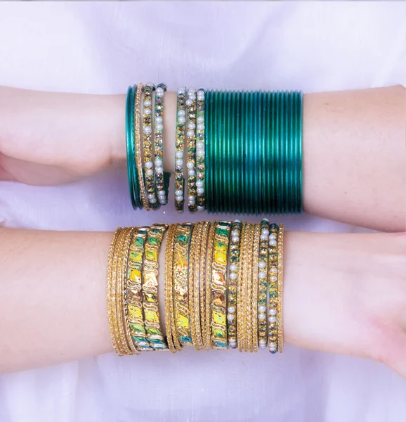 Girl hands with golden bracelets — Stock Photo, Image
