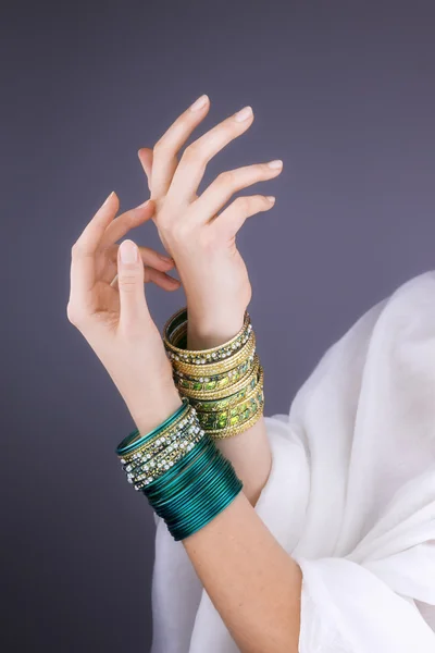 Girl hands with golden bracelets — Stock Photo, Image