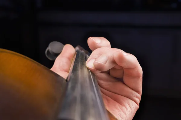 Men's hand on violin's fingerboard — Stock Photo, Image