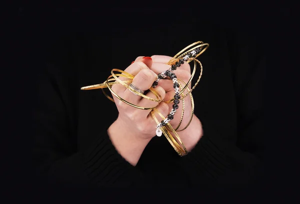 Woman's hands with golden bracelets — Stock Photo, Image