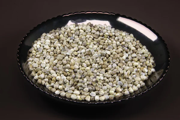 Hemp seeds on a dark plate — Stock Photo, Image