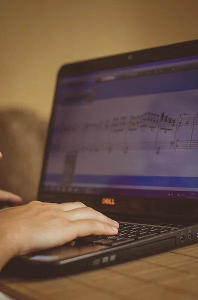 young composer writes music in the electronic program