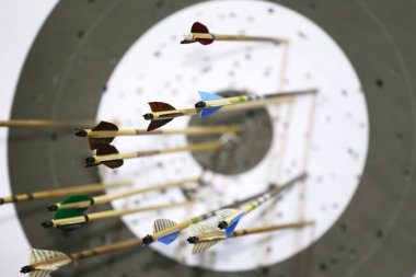 Targets at a bow shooting range with arrows in them clipart